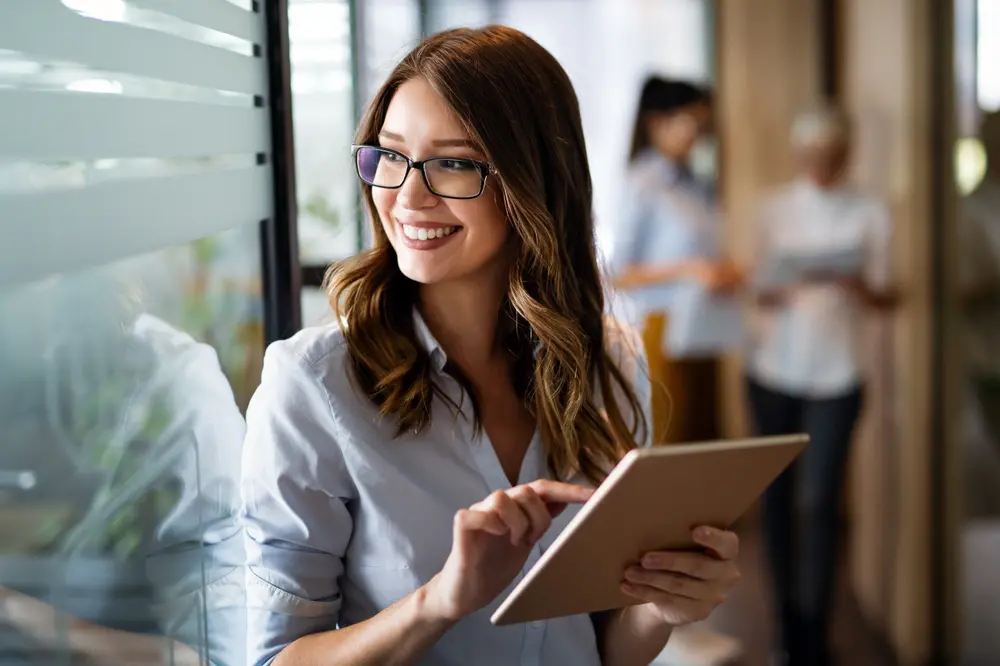 Woman using Tab to develop digital marketing strategy for auto dealership.
