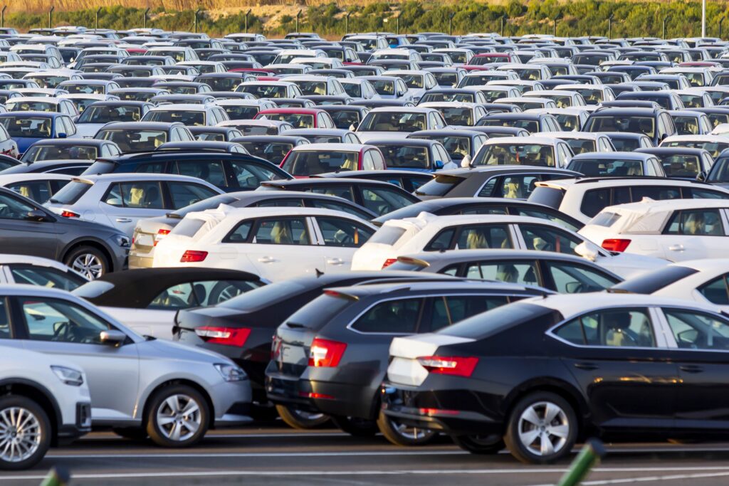 Bunch of new cars parked in dealer's parking area